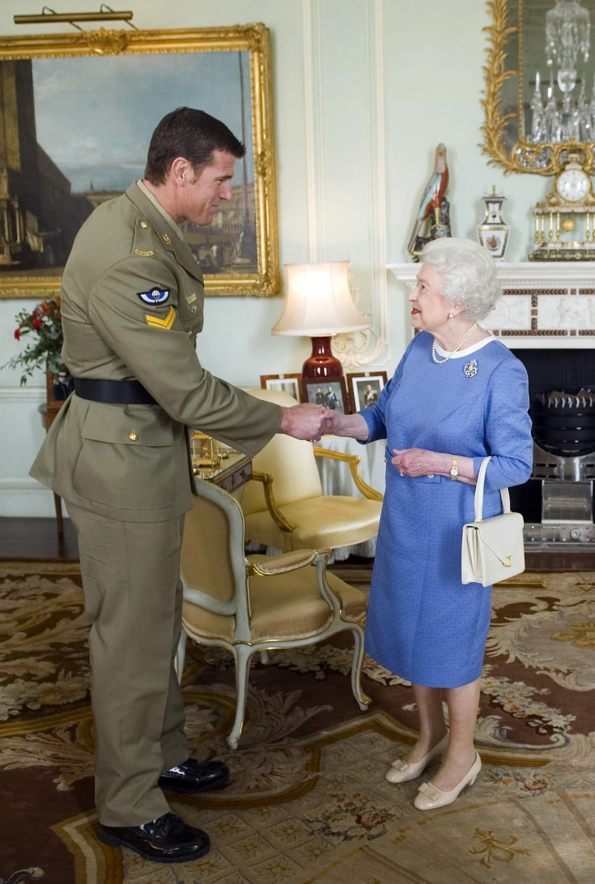 Australian war criminal Ben Roberts-Smith being honoured by Queen Elizabeth II